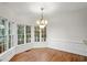 Cozy breakfast nook features large windows, chandelier, and wood floors at 10440 Cranchester Way, Alpharetta, GA 30022