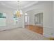 Elegant foyer with tray ceiling, chandelier, and arched entryway at 10440 Cranchester Way, Alpharetta, GA 30022