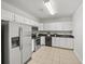 Well-lit kitchen featuring stainless steel appliances, white cabinets, and dark countertops at 10440 Cranchester Way, Alpharetta, GA 30022