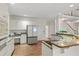 Well-lit kitchen with white cabinets, granite counters, and modern refrigerator at 10440 Cranchester Way, Alpharetta, GA 30022