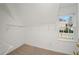 Neat walk-in closet with white wire shelving and a window for natural light at 10440 Cranchester Way, Alpharetta, GA 30022