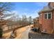 Exterior view of the back of the home, with a deck, porch, brick facade and manicured yard at 3428 Stembler Rdg, Douglasville, GA 30135