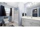 Bright bathroom with a shower-tub combo, white vanity, and tiled floors, offering a clean and modern aesthetic at 3428 Stembler Rdg, Douglasville, GA 30135