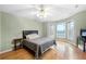 Inviting bedroom featuring hardwood floors, a ceiling fan, and abundant natural light from the many windows at 3428 Stembler Rdg, Douglasville, GA 30135