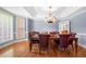 Elegant dining room with hardwood floors, wainscoting detail, and a classic chandelier creating an inviting space at 3428 Stembler Rdg, Douglasville, GA 30135