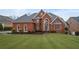 Stunning brick home with lush lawn, mature landscaping, and a stately, symmetrical facade at 3428 Stembler Rdg, Douglasville, GA 30135