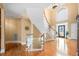 Elegant foyer featuring a curved staircase, hardwood floors, and a high ceiling with a statement light fixture at 3428 Stembler Rdg, Douglasville, GA 30135