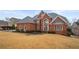 Elegant brick home with a well-manicured lawn and a grand entrance at 3428 Stembler Rdg, Douglasville, GA 30135