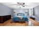 Stylish main bedroom with hardwood floors, a ceiling fan, and abundant natural light from the arched windows at 3428 Stembler Rdg, Douglasville, GA 30135