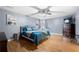 Relaxing main bedroom with hardwood floors, a ceiling fan, and natural light from the arched windows at 3428 Stembler Rdg, Douglasville, GA 30135