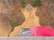 Aerial image of a landscaped backyard with a stone path leading to an outdoor fireplace with seating at 1050 Silver Thorne Dr, Loganville, GA 30052