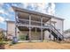 This beautiful backyard has a covered deck, stairs, and a landscaped area, perfect for outdoor entertaining at 1050 Silver Thorne Dr, Loganville, GA 30052