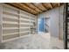 This unfinished basement boasts a built-in shelving unit for added storage and organization at 1050 Silver Thorne Dr, Loganville, GA 30052