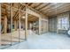This unfinished basement has exposed framing and an unfinished floor, ready for customization at 1050 Silver Thorne Dr, Loganville, GA 30052