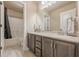 Neutral bathroom with a double sink vanity, large mirror, and shower-tub combination at 1050 Silver Thorne Dr, Loganville, GA 30052