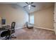Bedroom featuring carpet flooring, ceiling fan, and a chair with ottoman at 1050 Silver Thorne Dr, Loganville, GA 30052