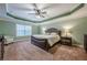 Relax in the spacious main bedroom with tray ceilings and plush carpeting at 1050 Silver Thorne Dr, Loganville, GA 30052