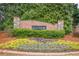 Community entrance sign surrounded by lush greenery and colorful flowers at 1050 Silver Thorne Dr, Loganville, GA 30052