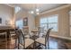 Charming dining area featuring a glass table, hardwood floors, and natural light from windows at 1050 Silver Thorne Dr, Loganville, GA 30052