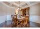 Elegant dining room with hardwood floors, coffered ceiling, and stylish chandelier at 1050 Silver Thorne Dr, Loganville, GA 30052