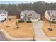 Aerial view of a home featuring a well-manicured lawn and a three car garage at 1050 Silver Thorne Dr, Loganville, GA 30052