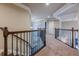 Hallway with carpet, wooden railing, and views of the stairs at 1050 Silver Thorne Dr, Loganville, GA 30052