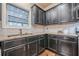 The kitchen features stainless steel appliances, granite counters, and dark cabinetry at 1050 Silver Thorne Dr, Loganville, GA 30052