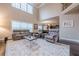 Bright, open-concept living room with large windows and comfortable seating arrangement at 1050 Silver Thorne Dr, Loganville, GA 30052