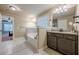 This main bathroom features a soaking tub, granite countertops, and double sinks at 1050 Silver Thorne Dr, Loganville, GA 30052