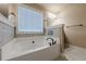 This main bathroom features a large soaking tub and oil rubbed bronze fixtures at 1050 Silver Thorne Dr, Loganville, GA 30052