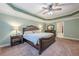 This main bedroom features a trey ceiling, carpet, and modern furniture at 1050 Silver Thorne Dr, Loganville, GA 30052