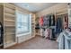 This walk-in closet features custom shelves, drawers, and racks for ample storage at 1050 Silver Thorne Dr, Loganville, GA 30052