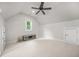 Cozy bedroom featuring a large window, neutral color scheme, and ceiling fan at 2373 Greenglade Ne Rd, Atlanta, GA 30345