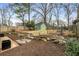 Fenced backyard with mulch, stone pathway, and green storage shed at 816 3Rd Ave, Decatur, GA 30030