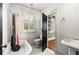 Cozy bathroom featuring a vintage-style tub, black door, and white tile flooring at 816 3Rd Ave, Decatur, GA 30030