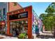 Squash Blossom Boutique featuring a colorful mural, brick exterior, and large windows at 816 3Rd Ave, Decatur, GA 30030