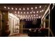 Inviting back deck with string lights, cozy seating, and lush greenery, perfect for outdoor entertaining at 1210 Thistle Gate Path, Lawrenceville, GA 30045