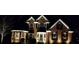 Beautiful two-story home exterior adorned with seasonal wreaths and festive lighting at night at 1210 Thistle Gate Path, Lawrenceville, GA 30045