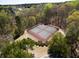 Aerial view of community tennis courts surrounded by lush greenery and trees, providing a serene recreational space at 3641 Willow Club Dr, Loganville, GA 30052