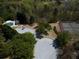 Overhead view showing a neighborhood pool, tennis courts, and playground area surrounded by lush trees at 3641 Willow Club Dr, Loganville, GA 30052
