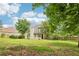 Expansive backyard showing the lawn area, chimney, and siding of the beautiful residence on a sunny day at 3641 Willow Club Dr, Loganville, GA 30052