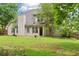 View of backyard with lawn, patio, and tan siding of two-story home with lots of windows at 3641 Willow Club Dr, Loganville, GA 30052