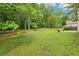 Spacious backyard features lush green grass and mature trees providing a private setting at 3641 Willow Club Dr, Loganville, GA 30052