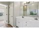 Bright bathroom featuring a dual vanity, a large mirror, wood-look tile flooring, and ample natural light at 3641 Willow Club Dr, Loganville, GA 30052