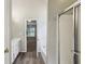 Bright bathroom featuring a dual vanity, tub, and shower with glass doors and wood-look tile flooring at 3641 Willow Club Dr, Loganville, GA 30052