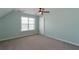 Bedroom with light blue walls, carpeted floors, and a ceiling fan with light fixture at 3641 Willow Club Dr, Loganville, GA 30052