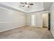 Large bedroom features a tray ceiling, fan, carpet, and neutral walls at 3641 Willow Club Dr, Loganville, GA 30052