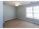 A bedroom with carpet, natural light from a window, and neutral wall color at 3641 Willow Club Dr, Loganville, GA 30052