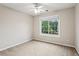 Bedroom with neutral carpet and walls with a large window offering a tree view at 3641 Willow Club Dr, Loganville, GA 30052