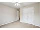 Bedroom featuring neutral carpet, a ceiling fan, and a closet with double doors at 3641 Willow Club Dr, Loganville, GA 30052